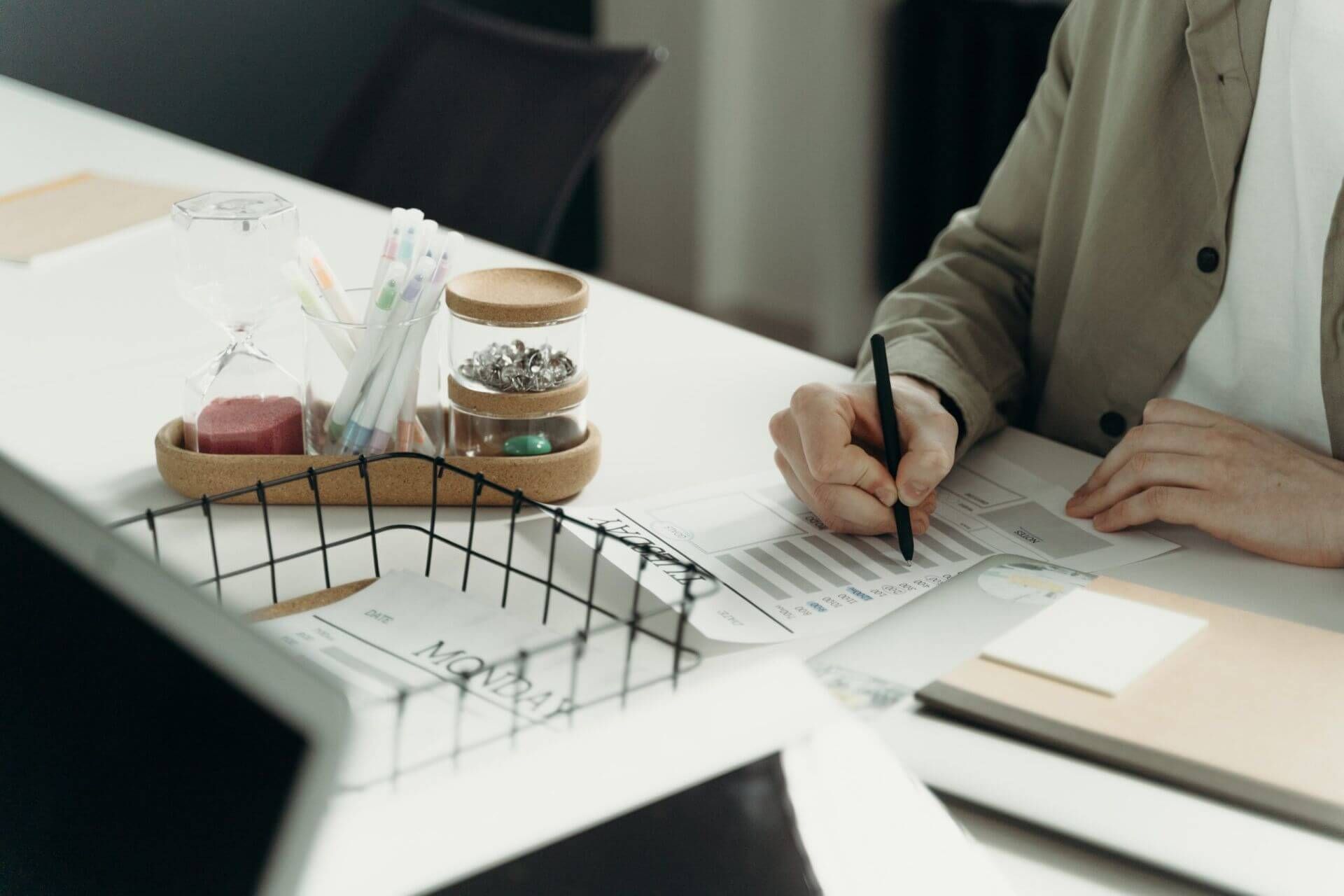 man sitting at a desk writing on paper