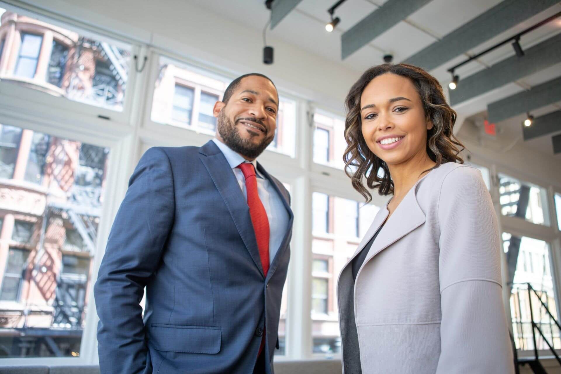 man and woman smiling looking at a camera