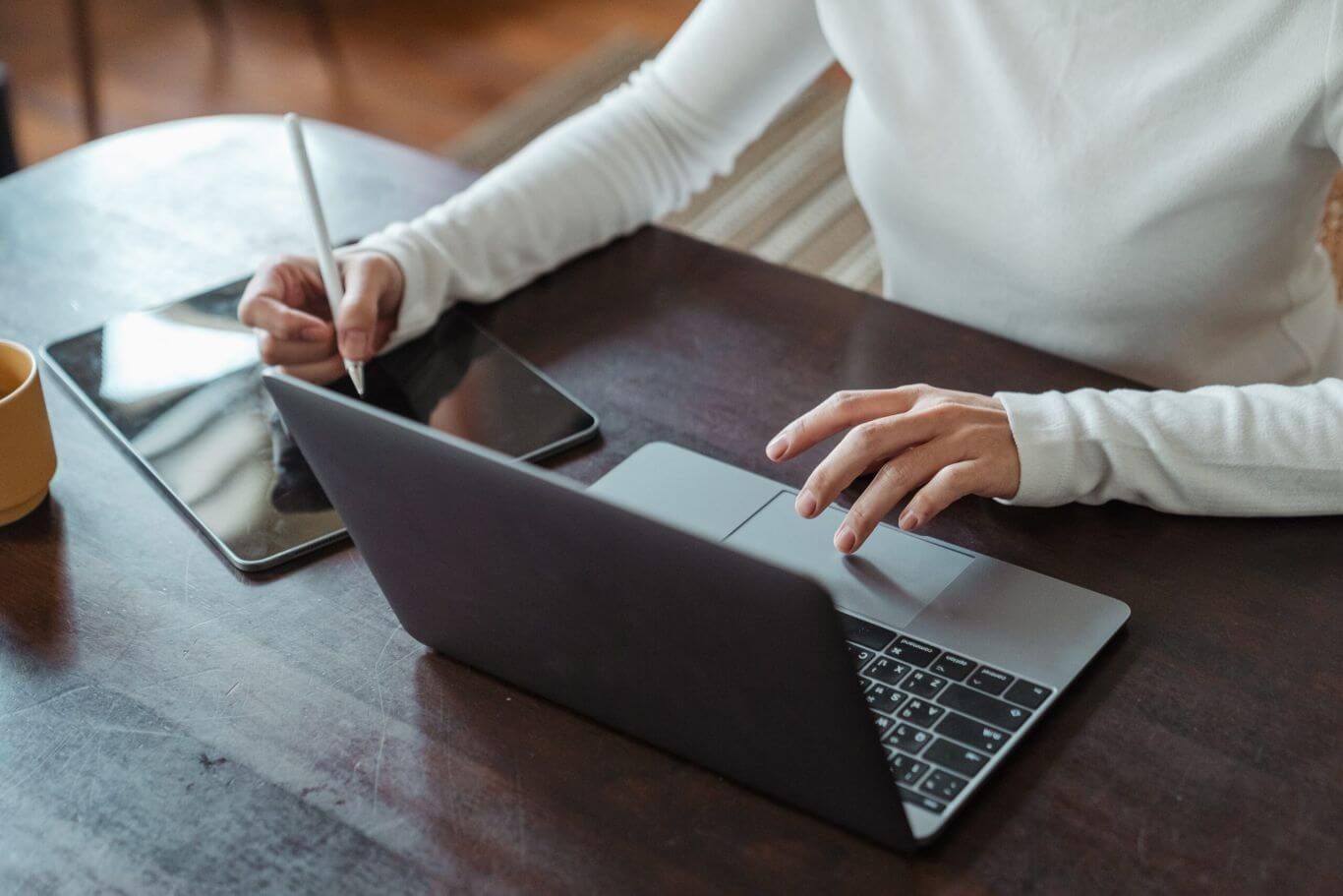 woman sitting down at a desk using a laptop